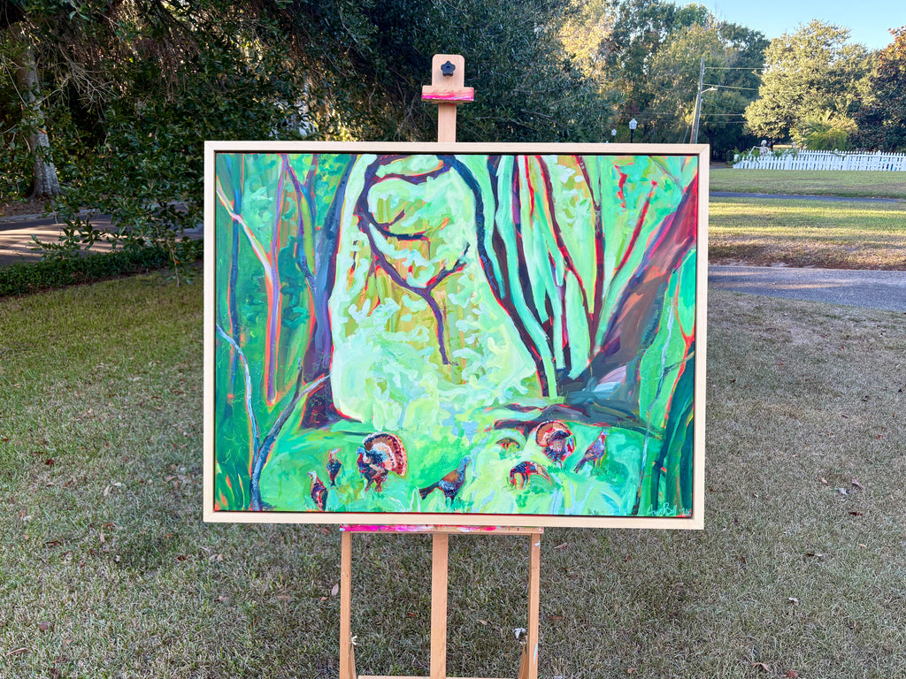 There's a Few of 'Em in its handmade poplar frame, displayed on an easel outdoors.