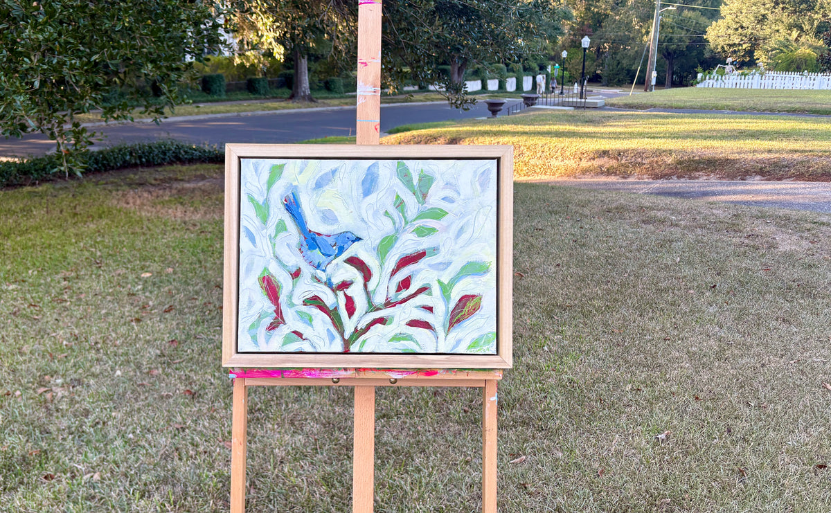 Look Who's Come Along displayed in its handmade poplar frame on an easel outdoors.