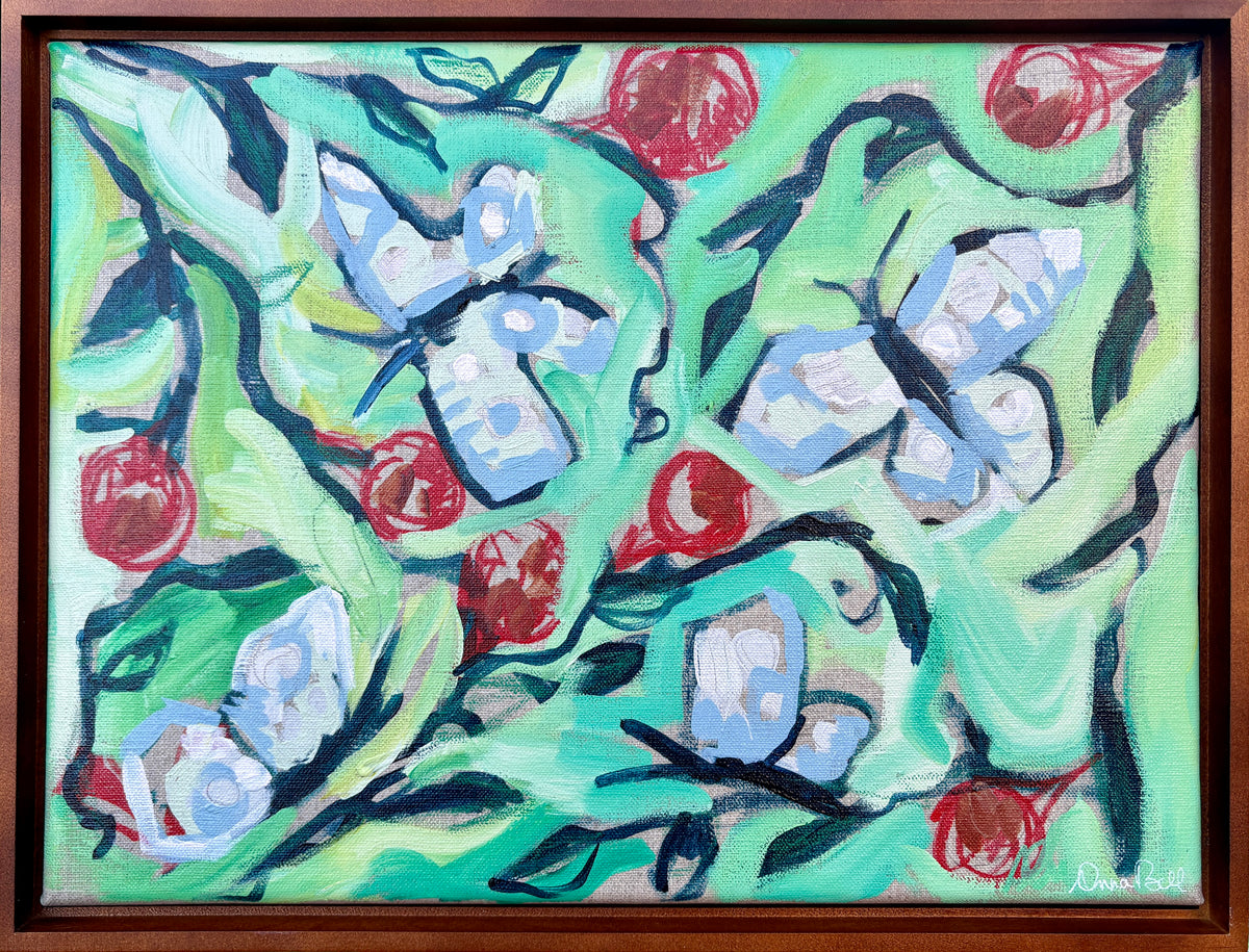 Look Who's In the Vines displayed in a brown frame on an easel outdoors.